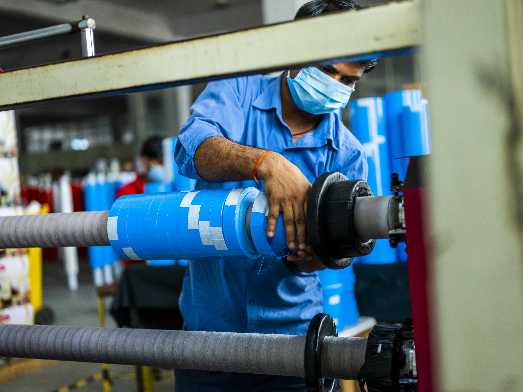 A worker operates a machine in a factory in Sonipat district, Haryana, India.