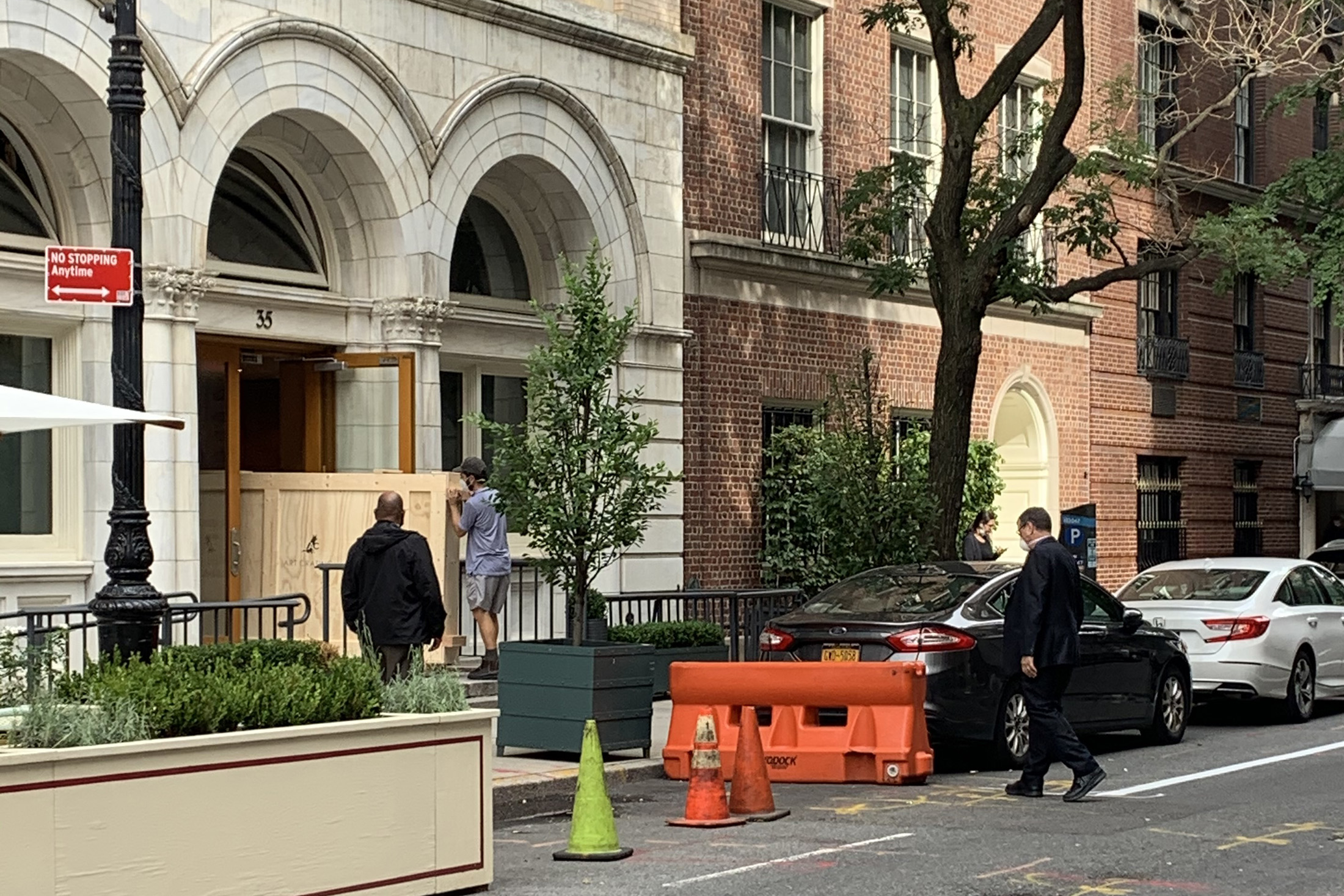 Workers remove crates of artwork from Ron Perelman's Upper East Side offices and into waiting trucks.