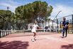 padel tennis players play on an outdoor court