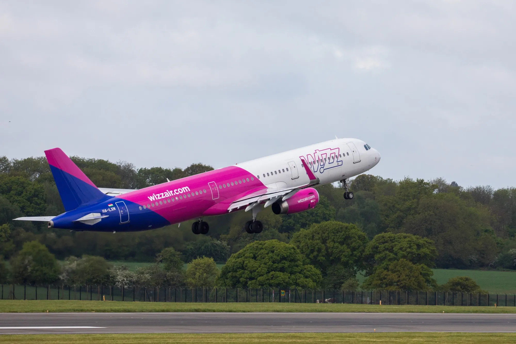 A Wizz Air Holdings Plc, airbus A321 takes off from London Luton Airport.