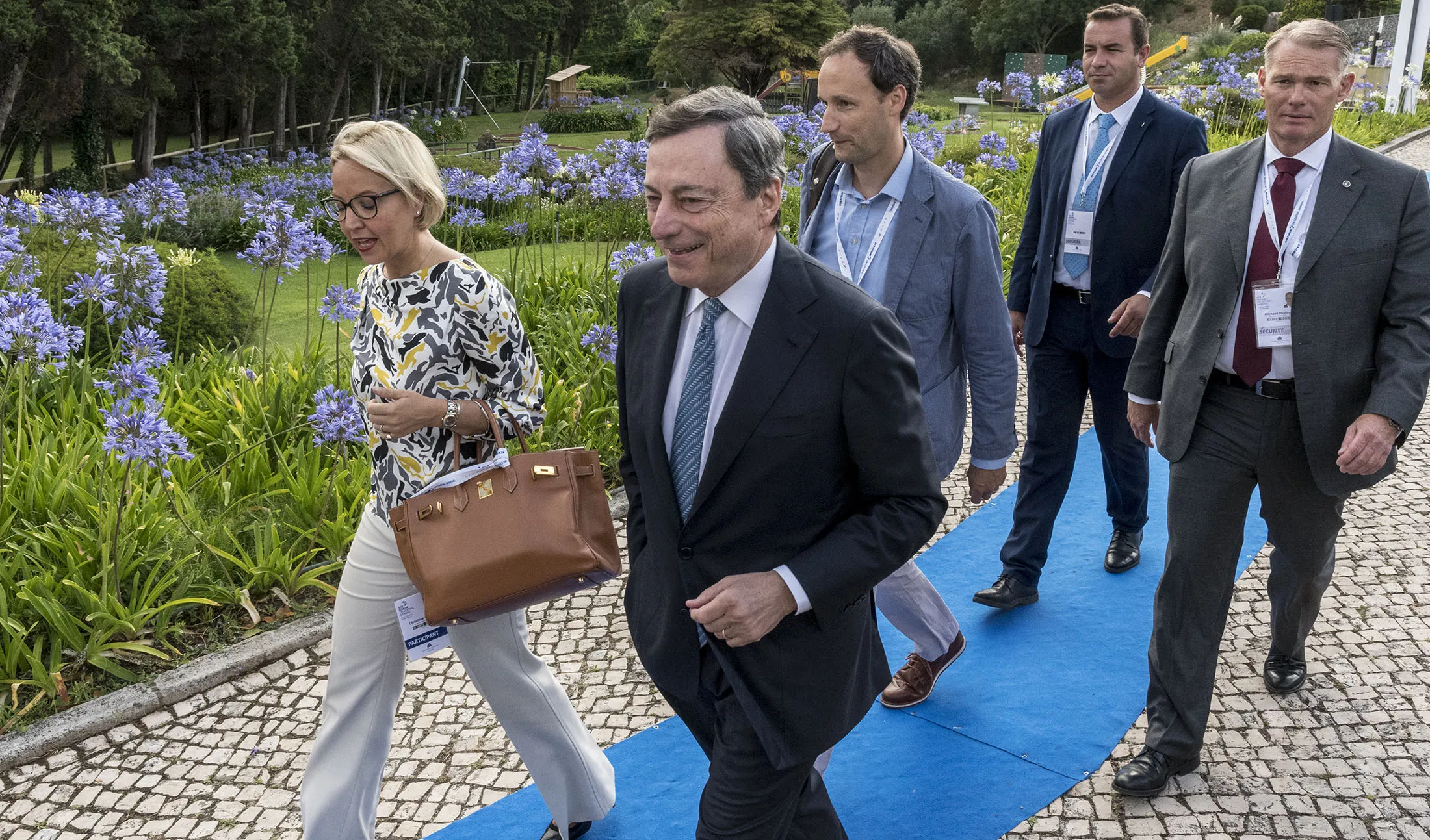 ECB President Mario Draghi, second left,&nbsp;arrives accompanied by ECB Director General Communications Christine Graeff, left, to deliver the opening speech at the first discussion session of the ECB Forum on Central Banking,&nbsp;in Sintra, Portugal, on June 27, 2017.
