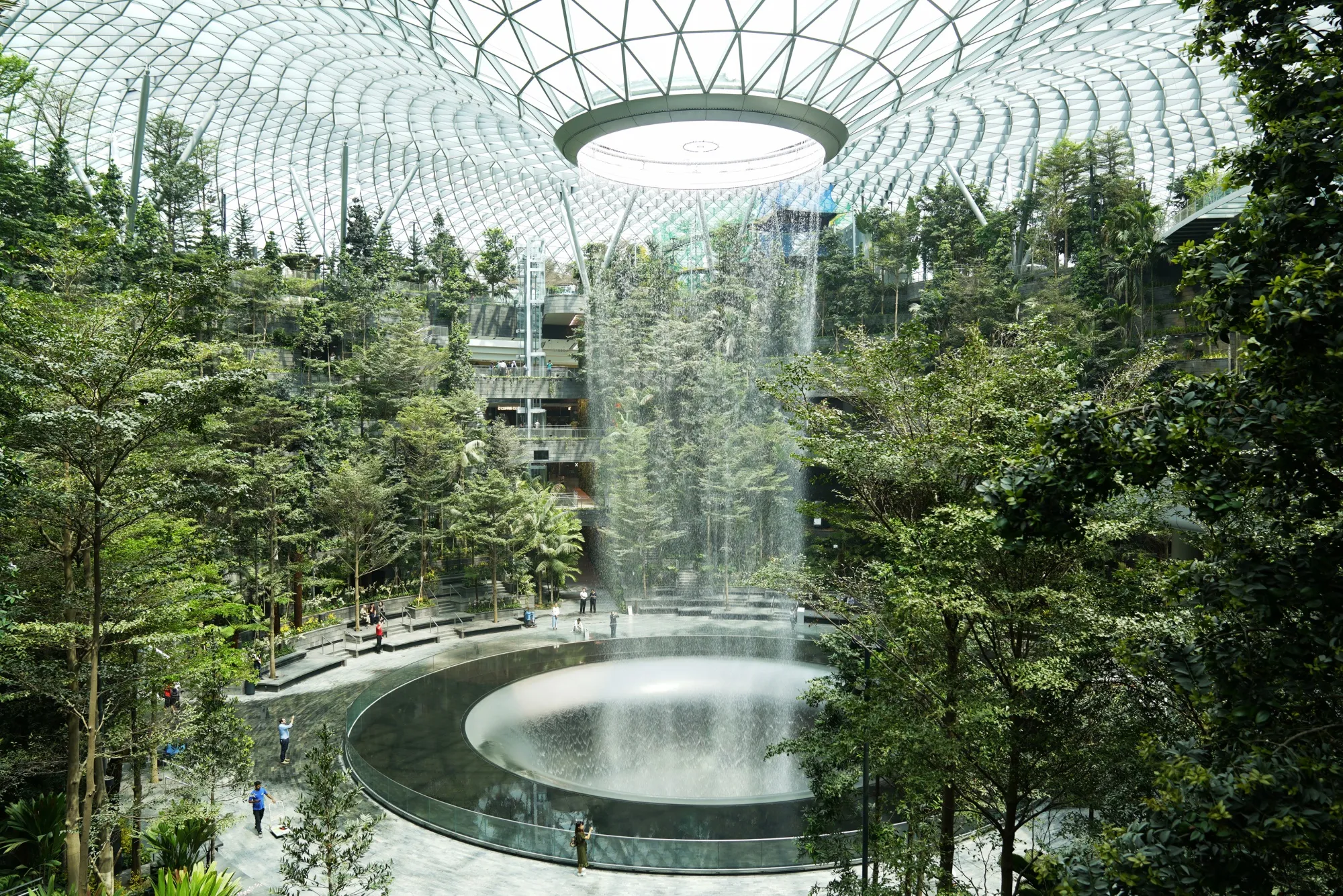 Water falls from the Rain Vortex at the Jewel Changi Airport.