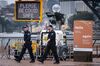 Signs are displayed in front of the Opera House in central Sydney on December 31.