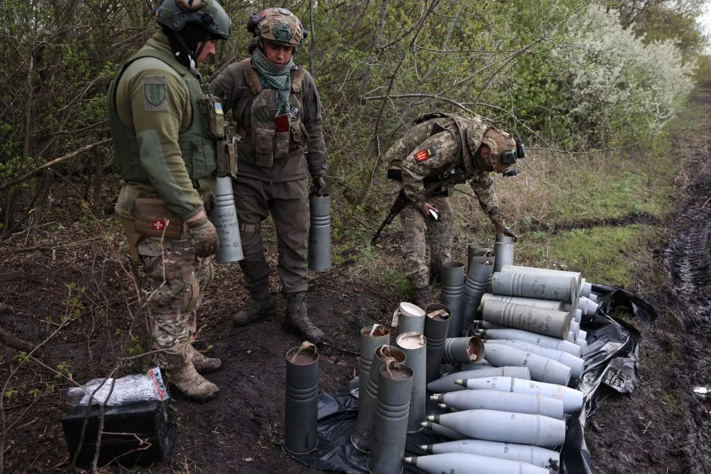 Ukrainian artillerymen with shells on a front line position near Bakhmut, Donetsk region, on April 22.