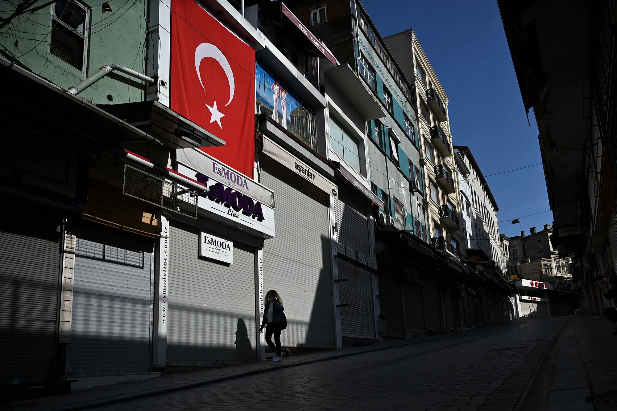 Closed shops in a deserted street during restrictions in Istanbul.