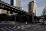 A man wearing a wearing a facemask as a preventive measure against the COVID-19 coronavirus crosses a street in Beijing on April 1, 2020.
