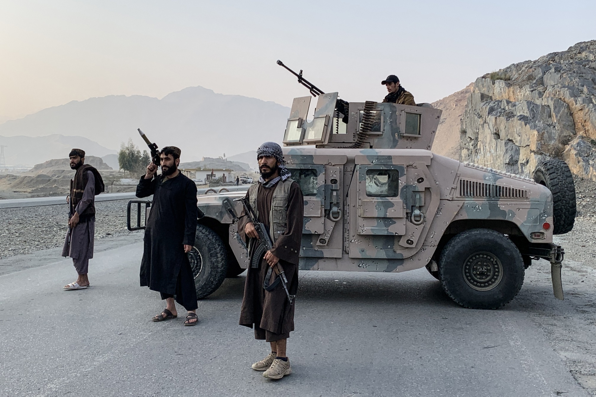 Taliban security personnel stand guard near the Torkham border crossing between Afghanistan and Pakistan in the Nangarhar province on Feb. 27. Photographer: Aimal Zahir/AFP/Getty Images