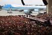 People listen as President Trump speaks during a rally in a hangar at Orlando Melbourne International Airport in Florida on Feb. 18, 2017.&nbsp;
