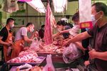Customers purchase pork at a food market in Shanghai.