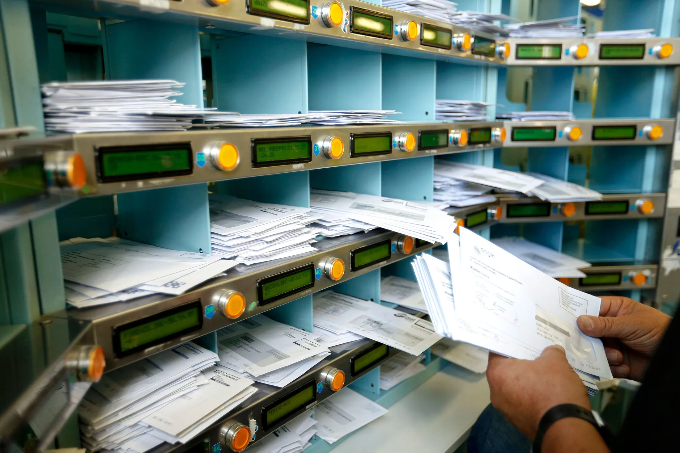 Mail is sorted inside a Poste Italiane sorting office in Fiumicino, near Rome.
