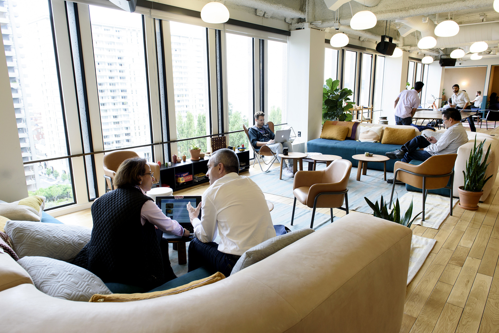 Members work on laptop computers in a common room at the Embarcadero WeWork Cos Inc. offices in San Francisco, California.
