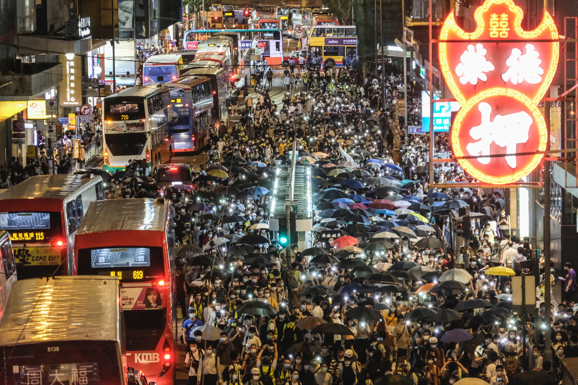 Demonstrators march on Des Voeux Road Central during a protest in Hong Kong, on June 9.