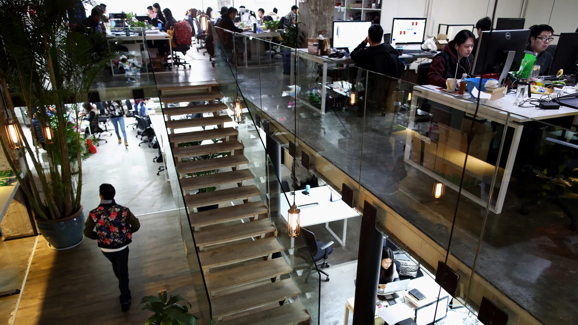 Workers use computers at their desks inside Tech Temple, a co-working space for start-up companies sponsored by Infinity Ventures Partners, in Beijing, China, on Thursday, March 12, 2015. China's central bank is easing monetary policy to support growth even as the U.S. Federal Reserve gets closer to raising borrowing costs.
