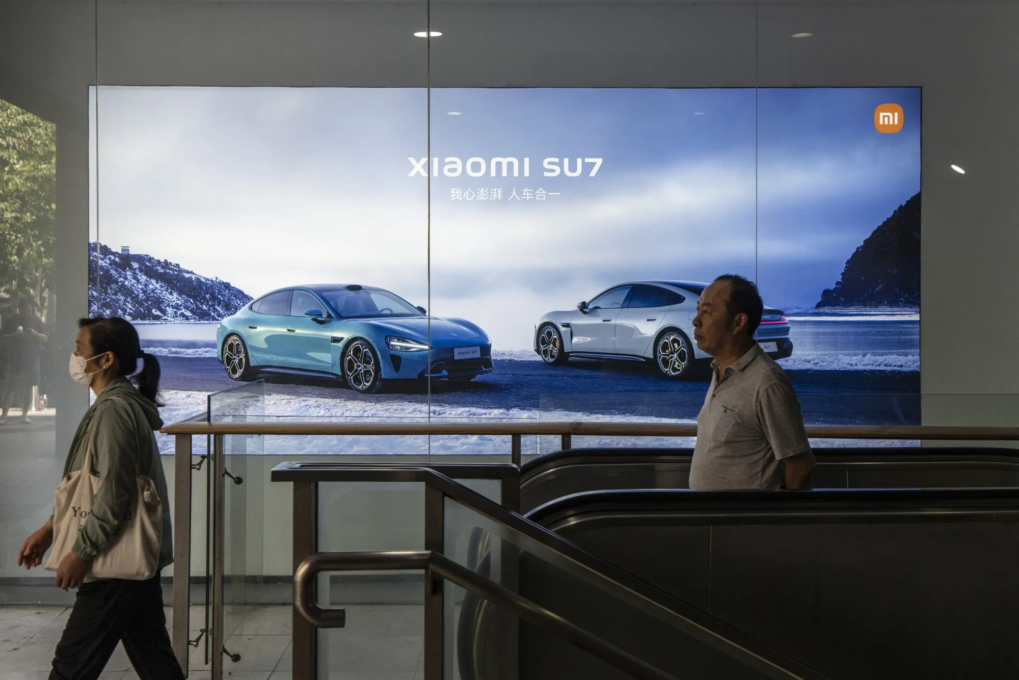 An advertisement for Xiaomi Corp.'s SU7 EV outside one of the company's stores in Shanghai.