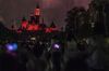 Visitors stand in front of the Sleeping Beauty Castle illuminated at night during the "Disney In the Stars" Fireworks performance at Walt Disney Co.'s Disneyland Resort in Hong Kong, China, on Friday, Aug. 7, 2015. Hong Kong is scheduled to release second-quarter gross domestic product figures on Aug. 14.
