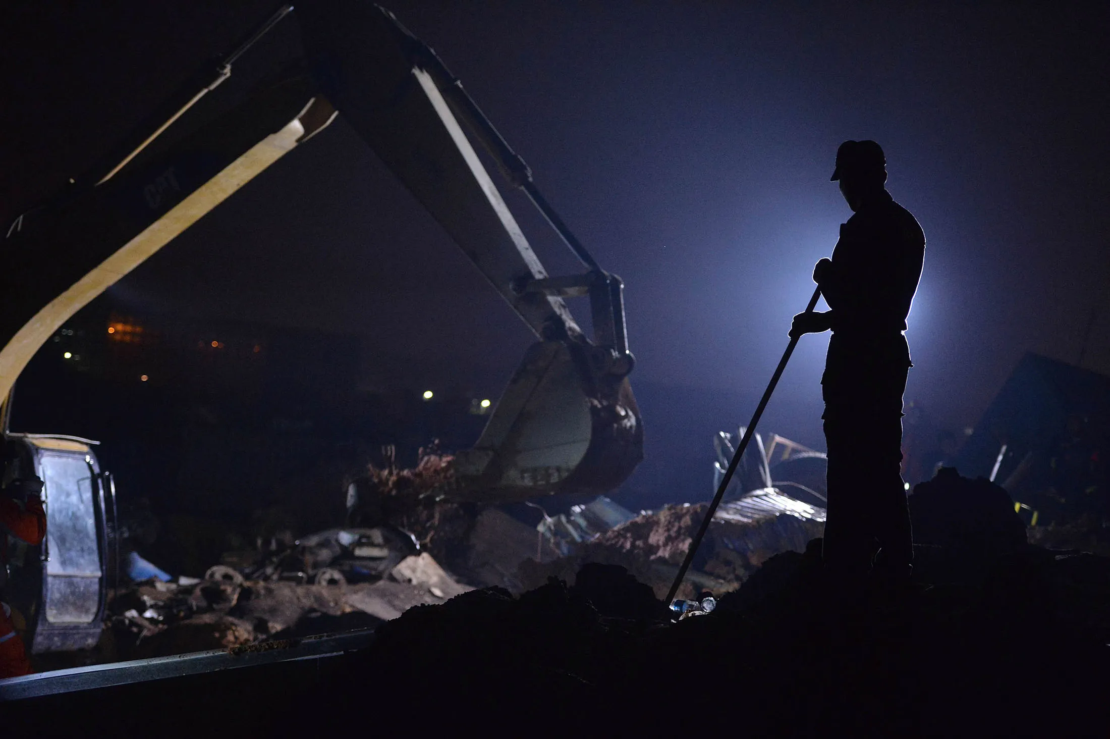 Rescuers search for survivors in the rubble of collapsed buildings.
