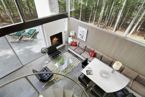 It has built-ins that fit the asymmetrical forms, including the original marble table.