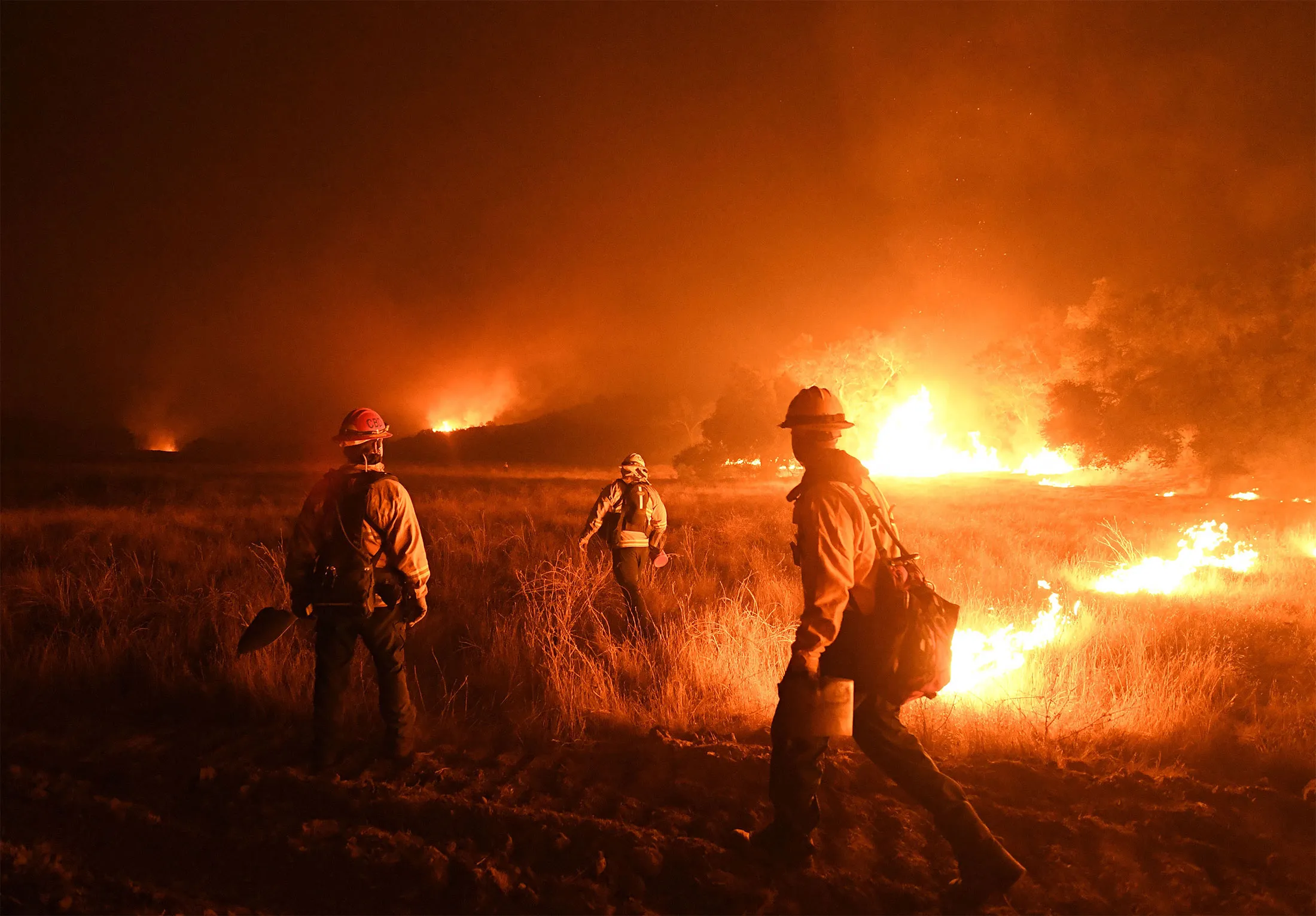 Firefighters light backfires as they try to contain the Thomas wildfire in Ojai, California, on Dec. 9, 2017.