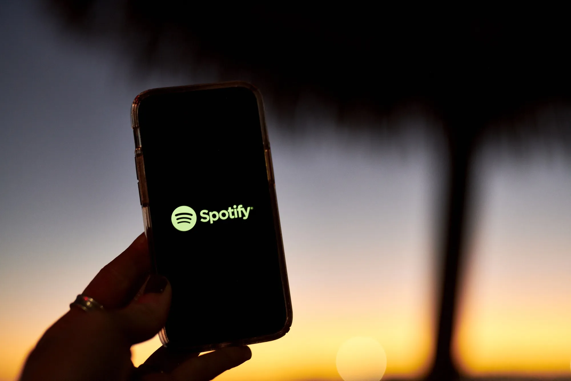 The Spotify logo on a smartphone in Saint Thomas, U.S. Virgin Islands, on Saturday, January 29, 2022. Spotify Technology SA outlined steps it will take to halt the spread of misleading information about Covid-19 on its audio-streaming service in an attempt to quell a growing controversy over its support for the podcast host Joe Rogan.