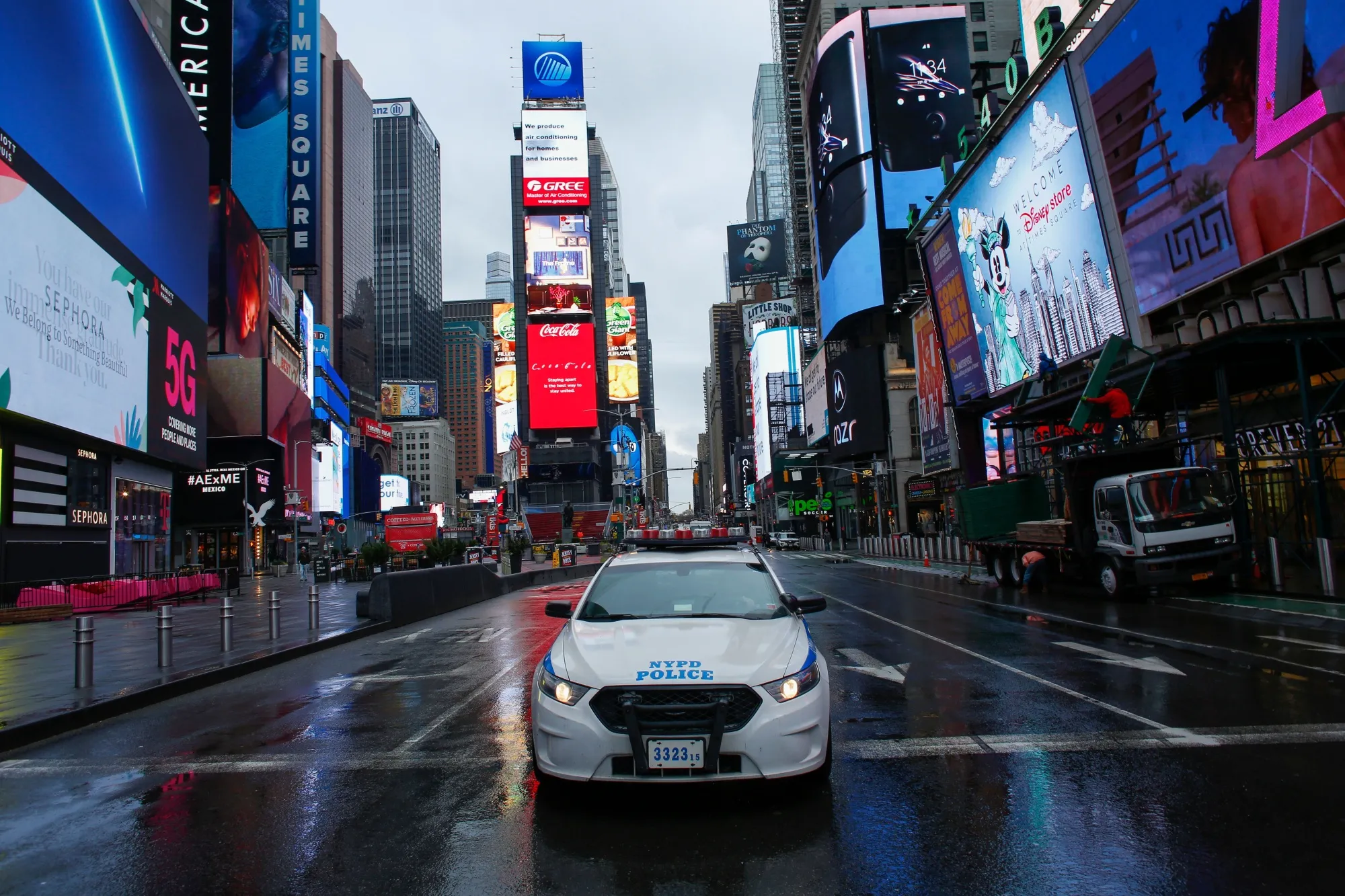 A NYPD car drives by Times Square in New York on March 28.