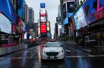 A NYPD car drives by Times Square in New York on March 28.
