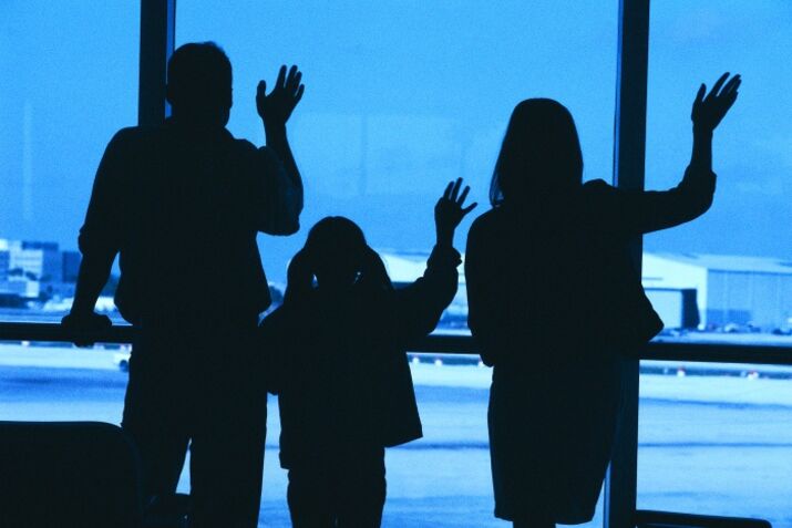 RF silhouette of a family waving through a window