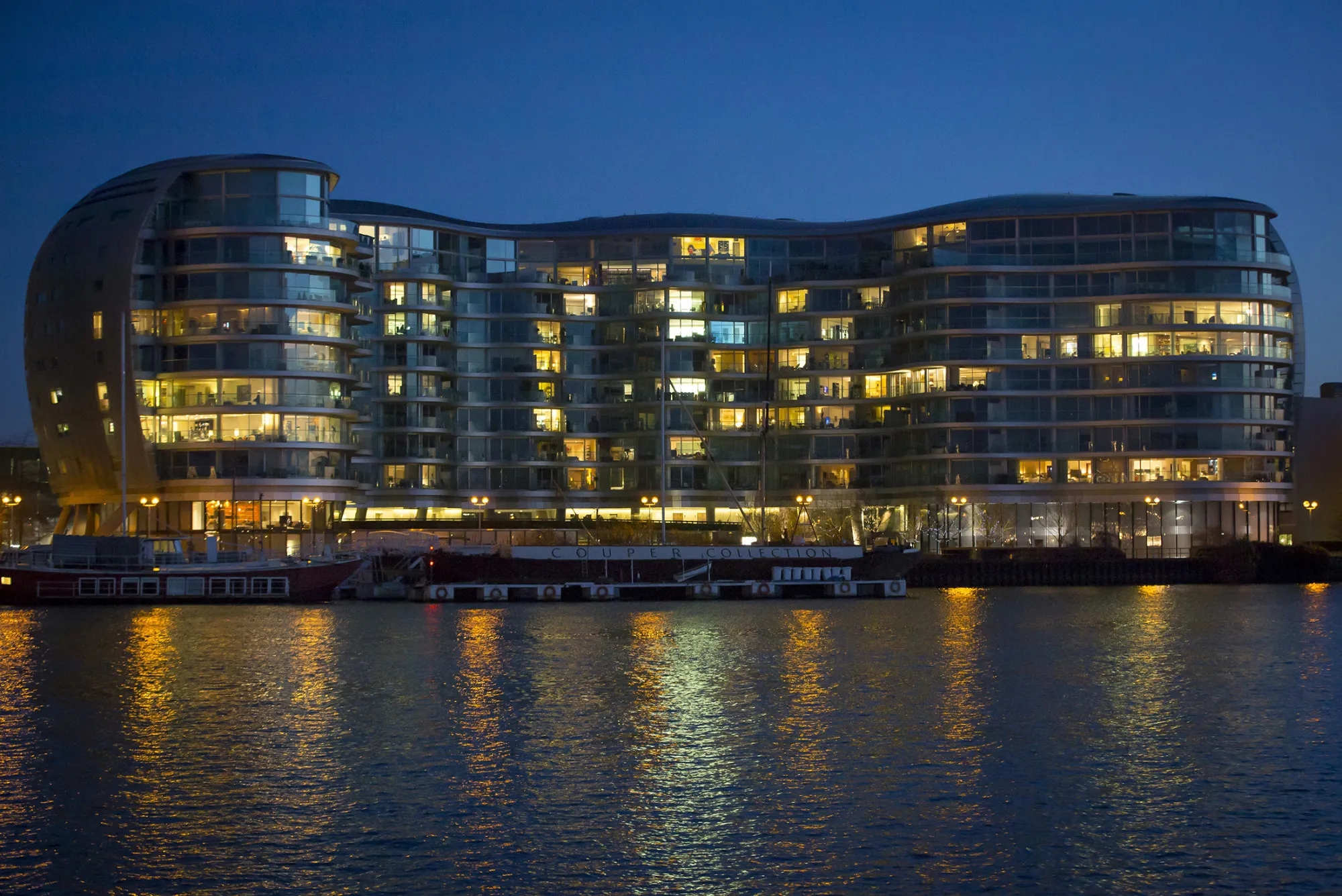 Residential apartments are seen illuminated at night at the Albion Riverside development in the Chelsea district of London, U.K., on Monday, March 4, 2013. Central London luxury-home prices unexpectedly rose at the fastest pace in 10 months in February as the British pound's depreciation helped attract international investors, Knight Frank LLP said.
