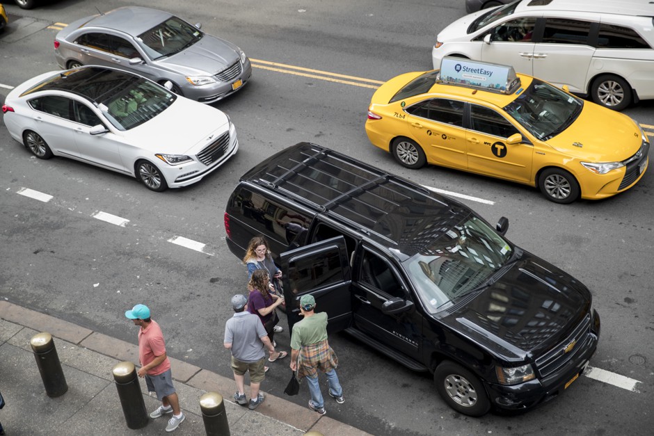 Traditional taxis vie for street space with ride-hailing vehicles from Uber and Lyft in New York City. Something has to give.