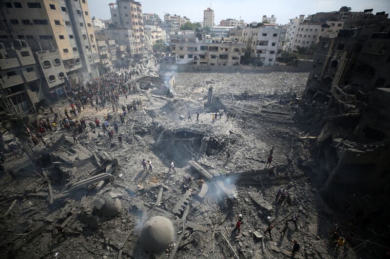 Palestinians inspect the damage following an Israeli airstrike on the Sousi mosque in Gaza City on October 9, 2023.