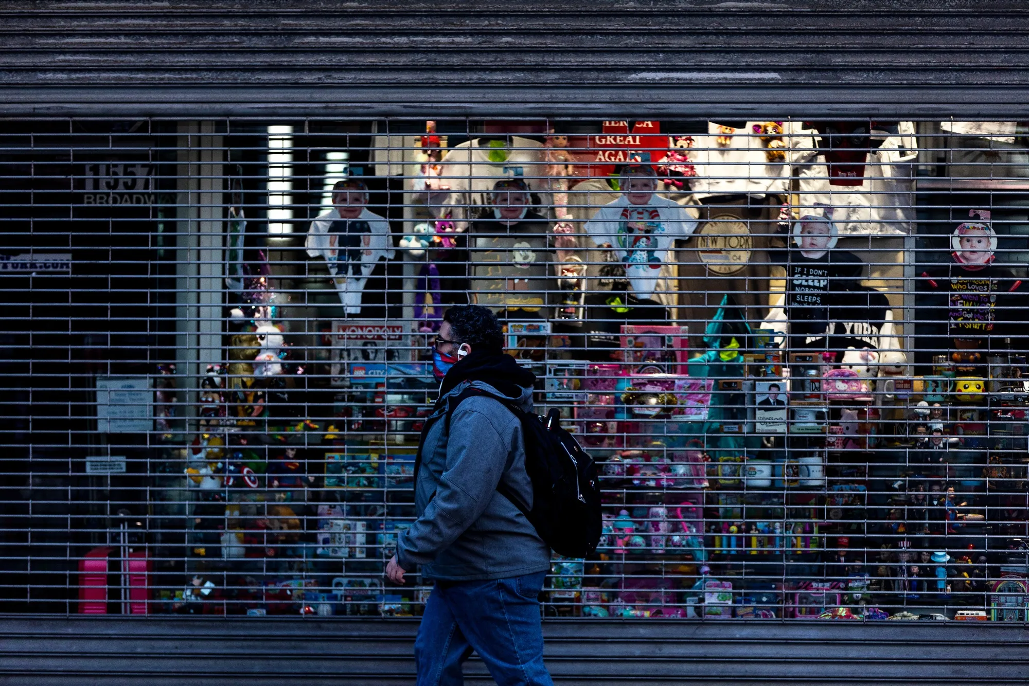 A pedestrian wearing a protective mask passes in front of a souvenir shop temporarily closed in the Times Square area of New York on May 12.