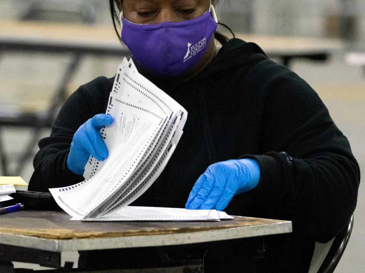&nbsp;Election officials count the votes for Fulton County in January 2021.