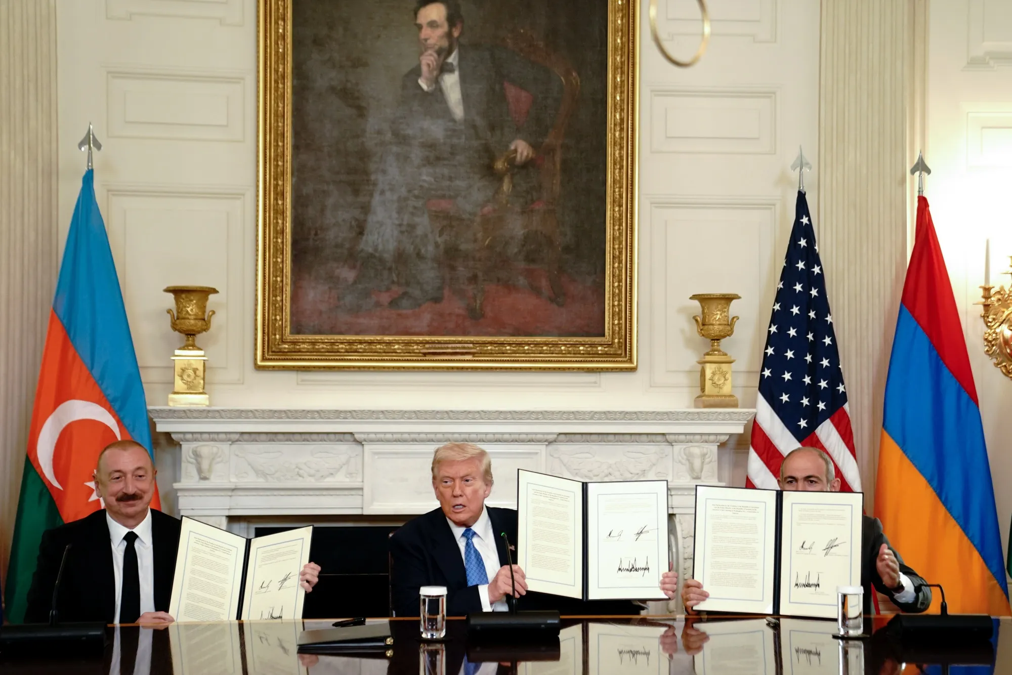 Azerbaijan's President Ilham Aliyev, from left, US President Donald Trump, and Armenia's Prime Minister Nikol Pashinyan&nbsp;display signed agreements during a ceremony at the White House in Washington on Aug. 8.