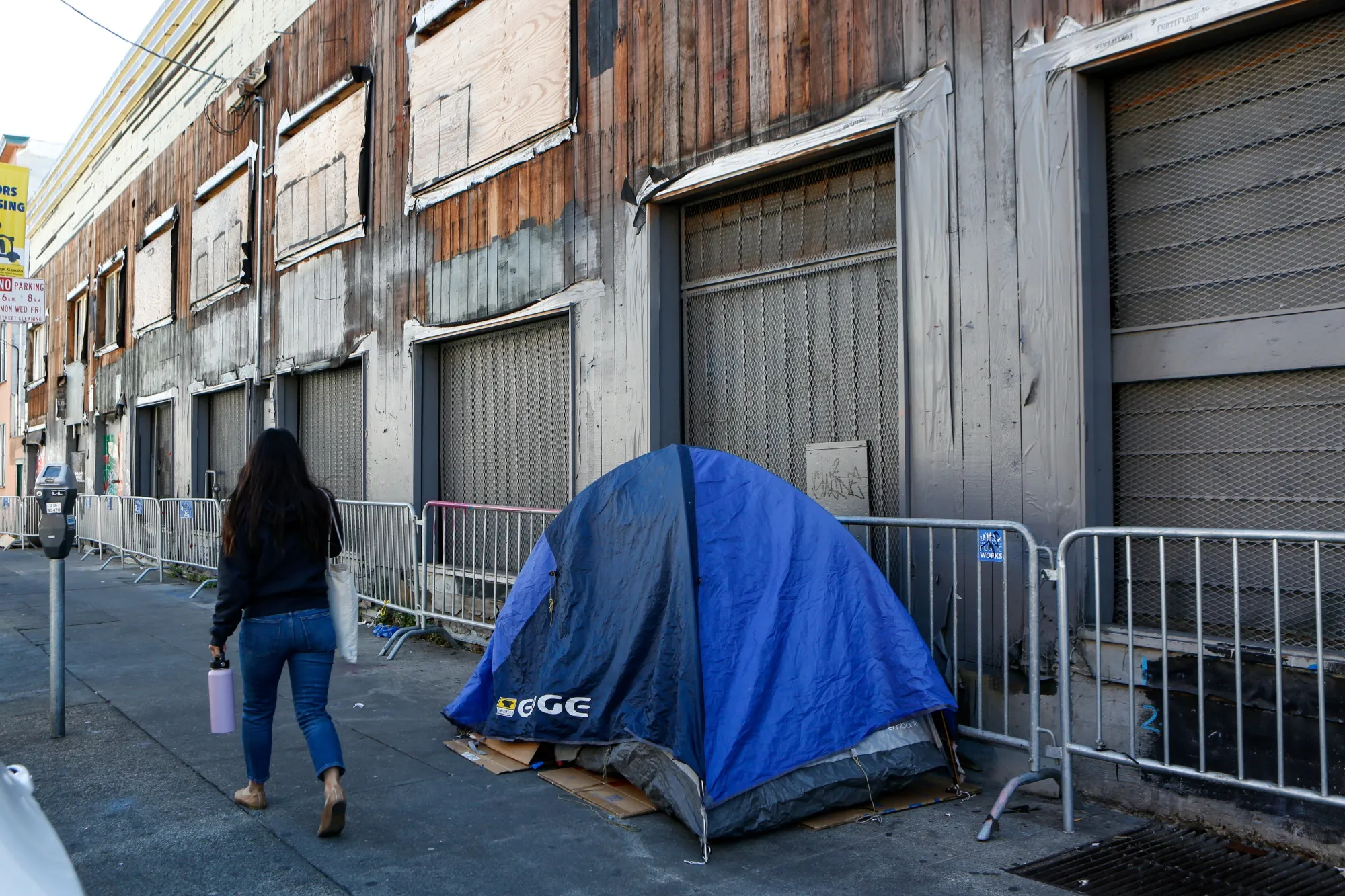 A pedestrian walks past a vacant building in San Francisco’s Mission District.