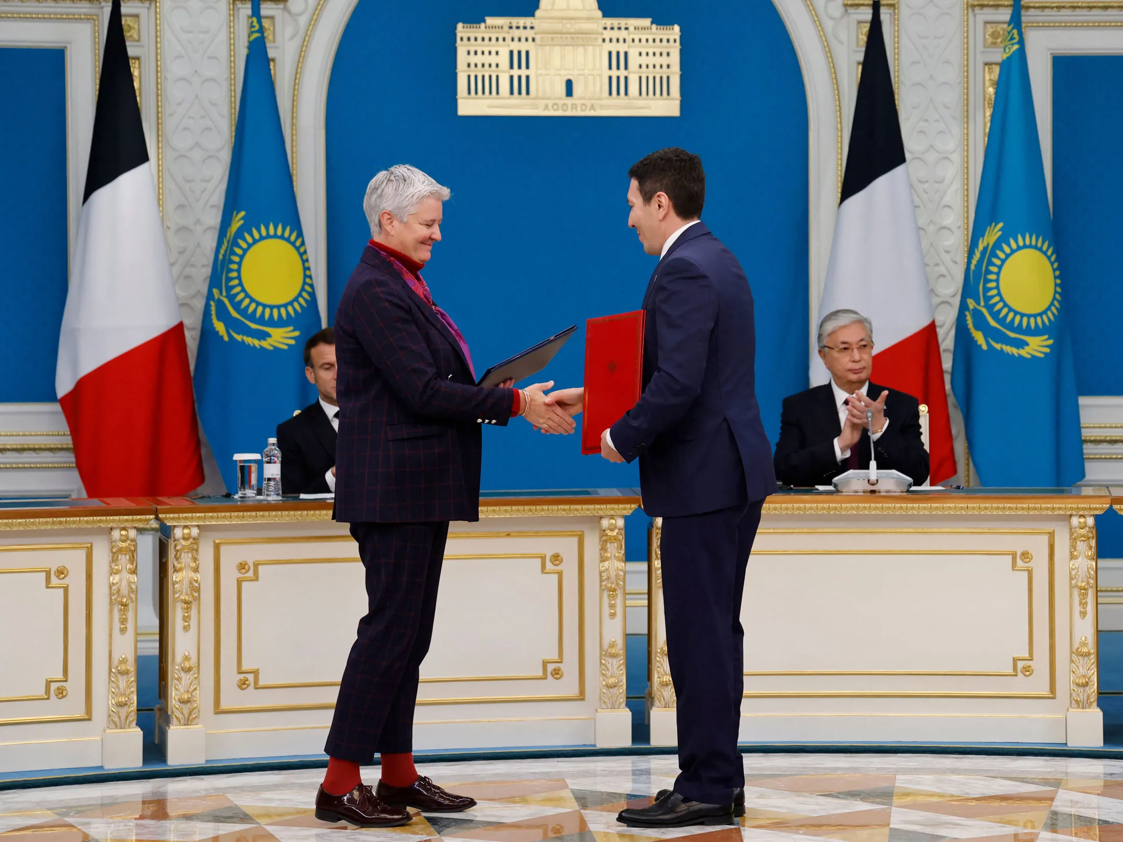 Fabienne Demol, left,&nbsp;signs a strategic investment contract with Nurlan Zhakupov in Astana on Nov. 1.