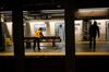 A Metropolitan Transit Authority (MTA) worker mops around a bench at a Times Square subway station in New York on April 21.