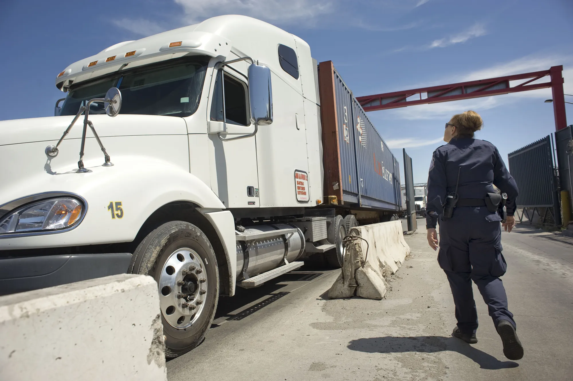 A U.S. Customs and Border Protection inspects a truck entering from Mexico at the Otay Mesa Cargo Port of Entry in San Diego.