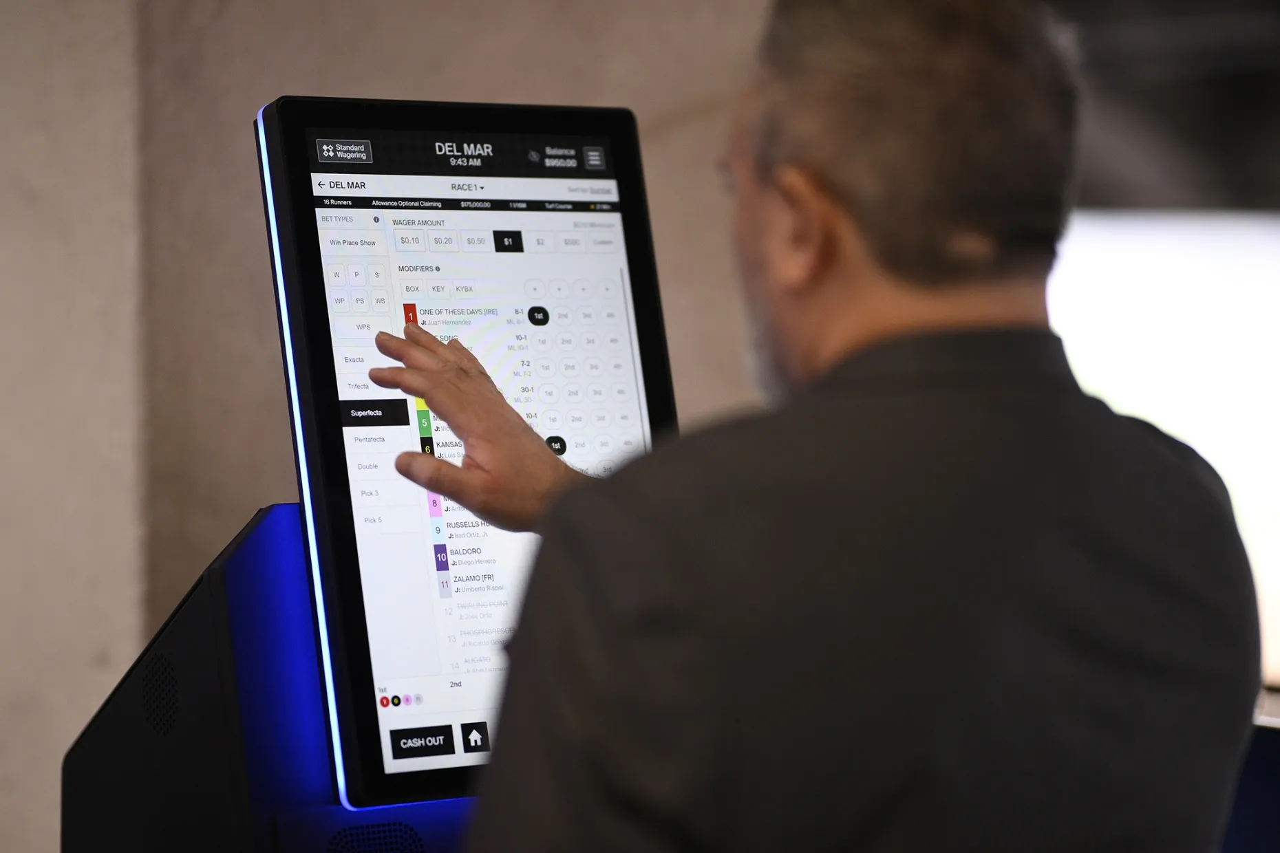 A patron places a bet during the 2025 Breeders' Cup World Championships at Del Mar Race Track in Del Mar, California.