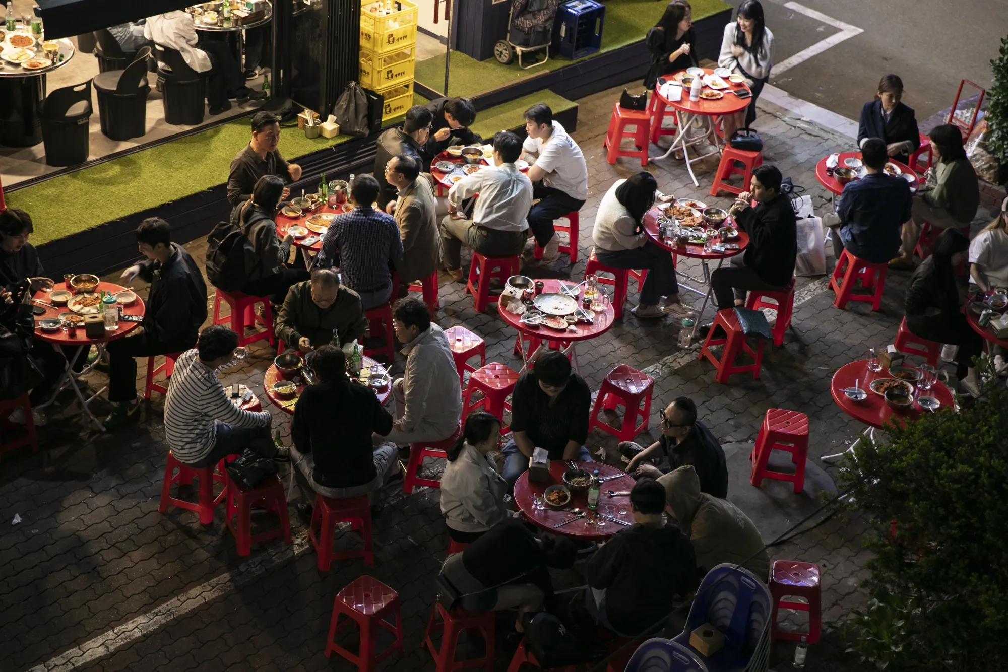 Customers dine at an outdoor restaurant at Sungsu district in Seoul, South Korea.