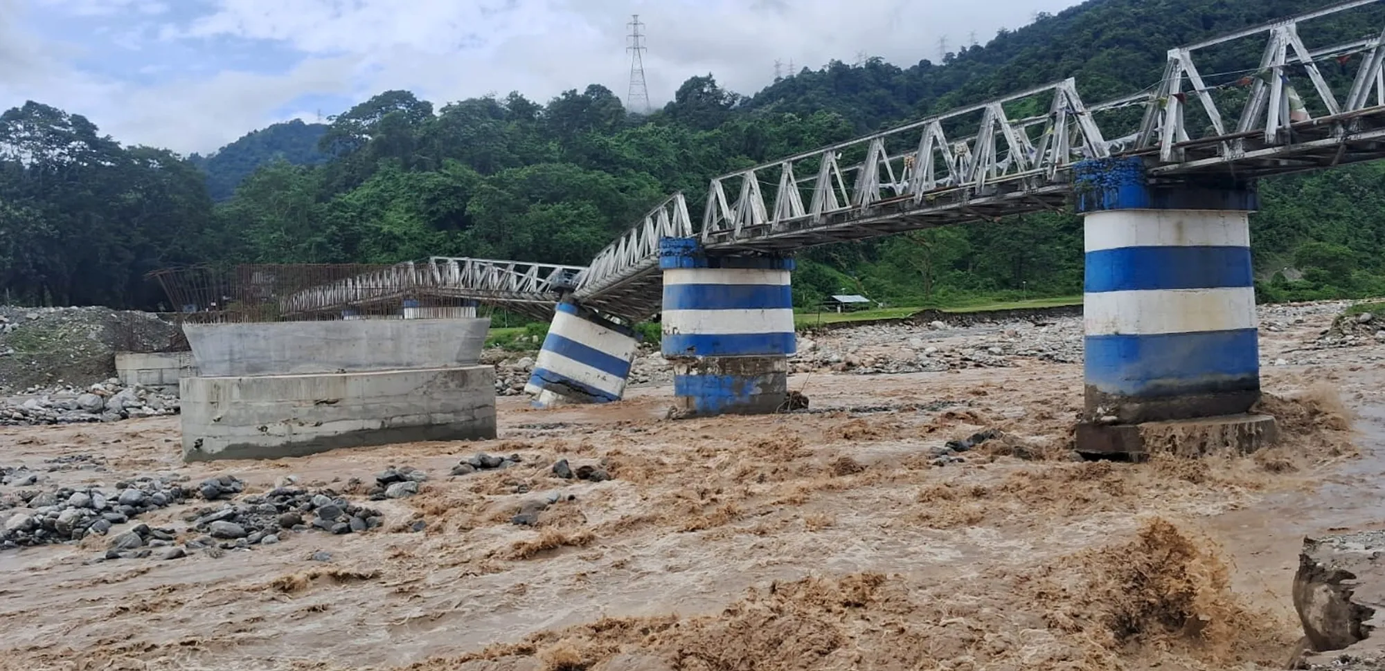 A washed-away portion of Dudhiya bridge on the outskirts of Siliguri, India, on Oct. 5.