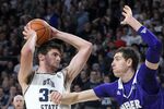 Utah State center Trevin Dorius (32) looks to shoot the ball as then-Weber State forward Dima Zdor, right,  defends during the second half of an NCAA college basketball game Friday, Nov. 8, 2019, in Logan, Utah. Zdor now plays for Grand Canyon. Ukrainians playing college basketball in the United States have tried to keep up their routines as Russia invades their home country. One of a handful of Ukrainians playing college basketball in the United States, Zdor can only watch from afar as Russian troops roll through his home country, hoping his family and friends remain safe. (AP Photo/Eli Lucero, File)