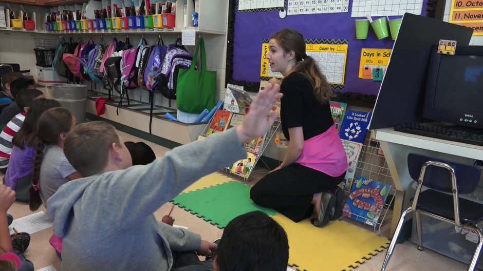 Elena Humpert, a junior at Northern Kentucky University, answers a student's question during a lesson at Florence Elementary.