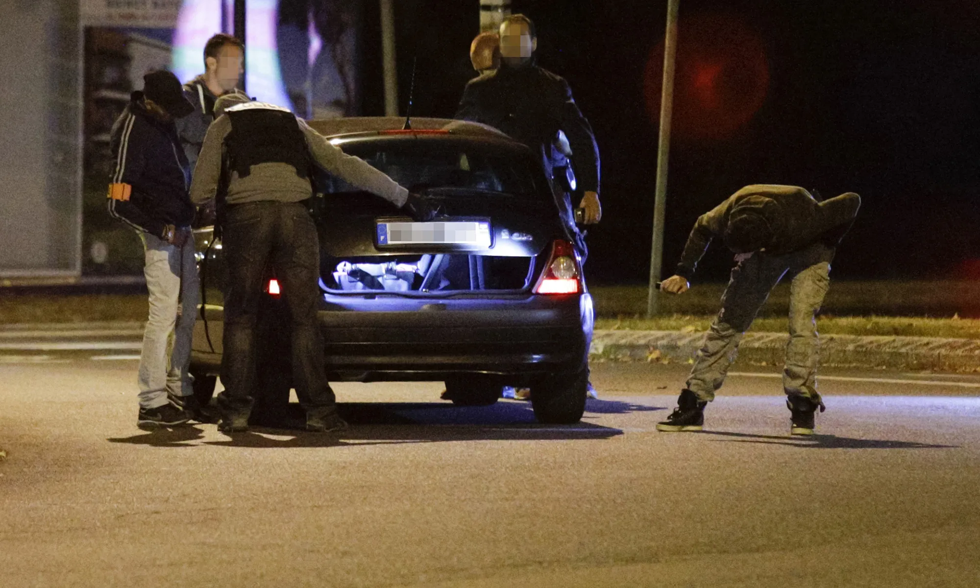 Policemen look at a car near a building in Boussy-Saint-Antoine, south of Paris, where suspects, said to have been planning new acts of violence, were arrested, on Sept. 8, 2016.
