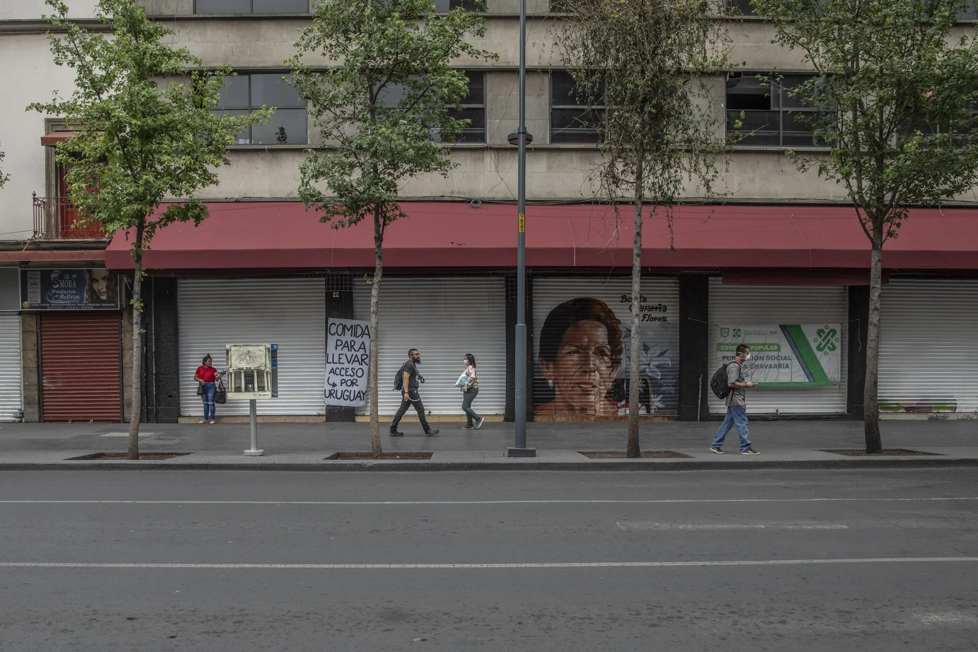 Pedestrians pass in front of temporarily closed businesses in Mexico City, Mexico, on&nbsp;May 5.&nbsp;