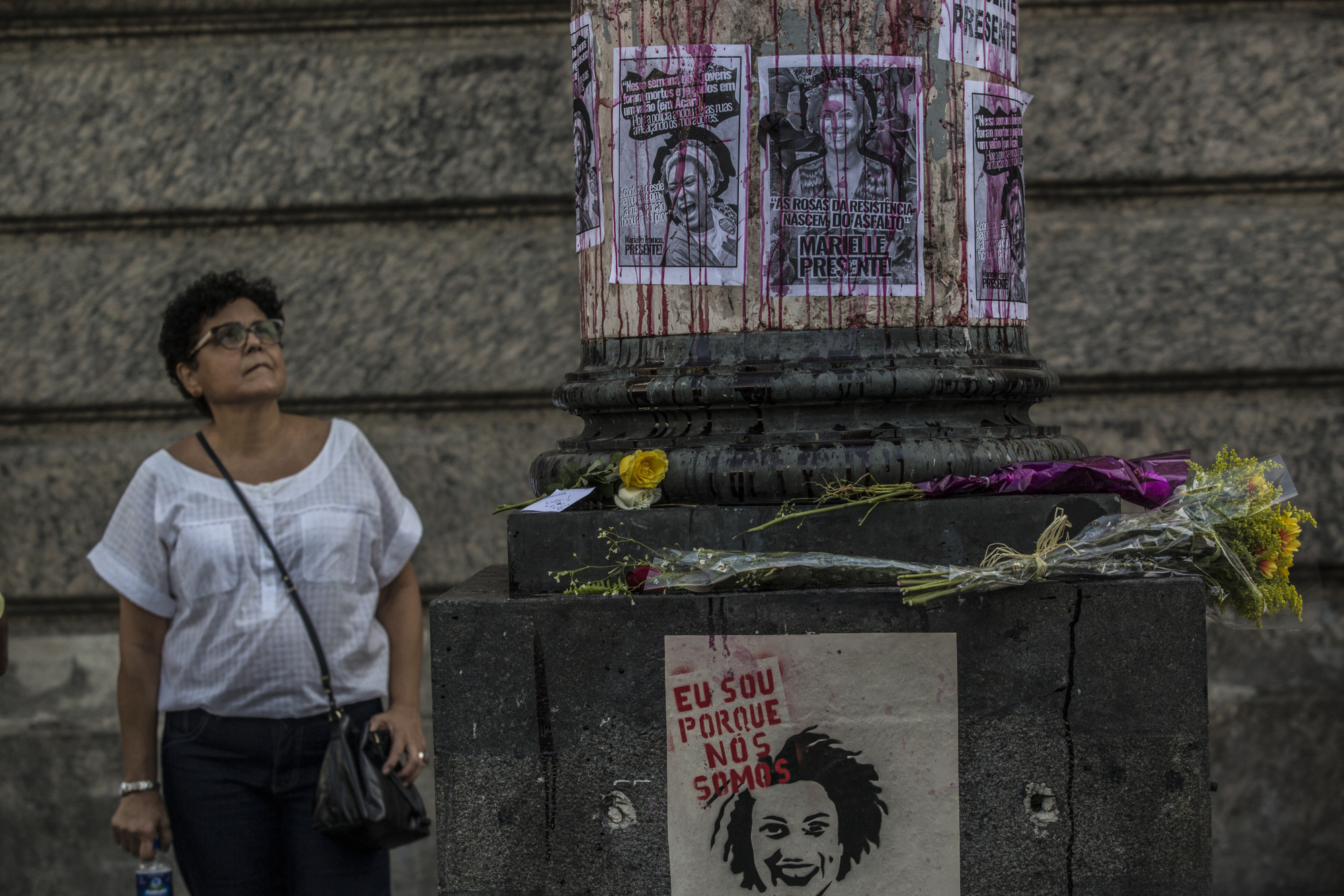 Posters depicting councilwoman Marielle Franco hang on display, the day after she was murdered, in Rio de Janeiro.