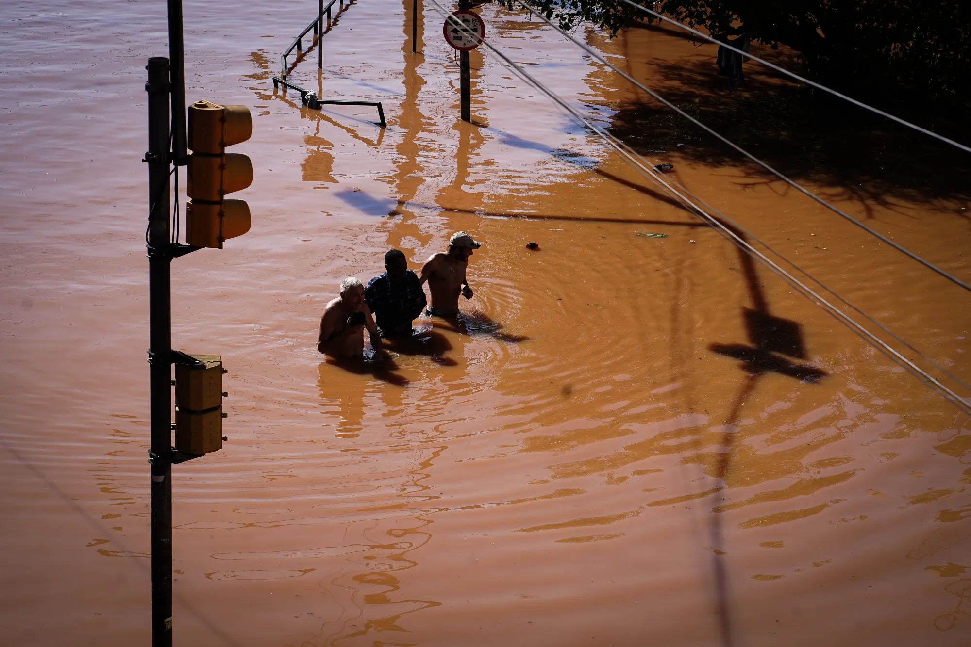 Residents walk through floodwater following heavy rains in Porto Alegre, Rio Grande do Sul state, Brazil, on&nbsp;May 6, 2024.