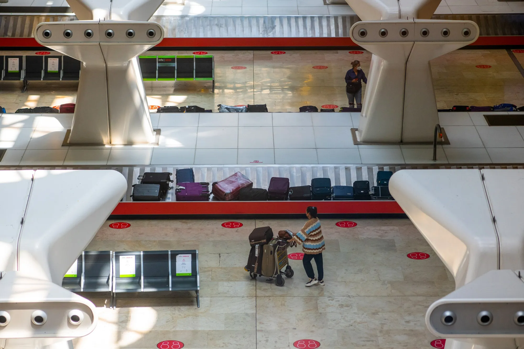 A passenger at the luggage reclaim area.