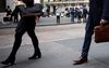 Pedestrians walk along Wall Street in front of the New York Stock Exchange (NYSE) in New York, U.S., on Monday, Oct. 15, 2018. U.S. stocks fell along with the dollar as political tensions added to a growing list of investor concerns.