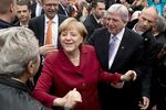 German Chancellor Angela Merkel is mobbed by supporters arriving at an election campaign event on Sept. 19