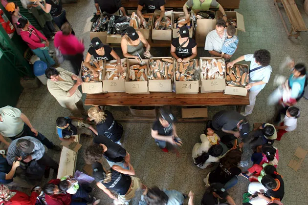 Members of the Toms Shoe team deliver 10,000 pairs at a Buenos Aires soup kitchen in Argentina.