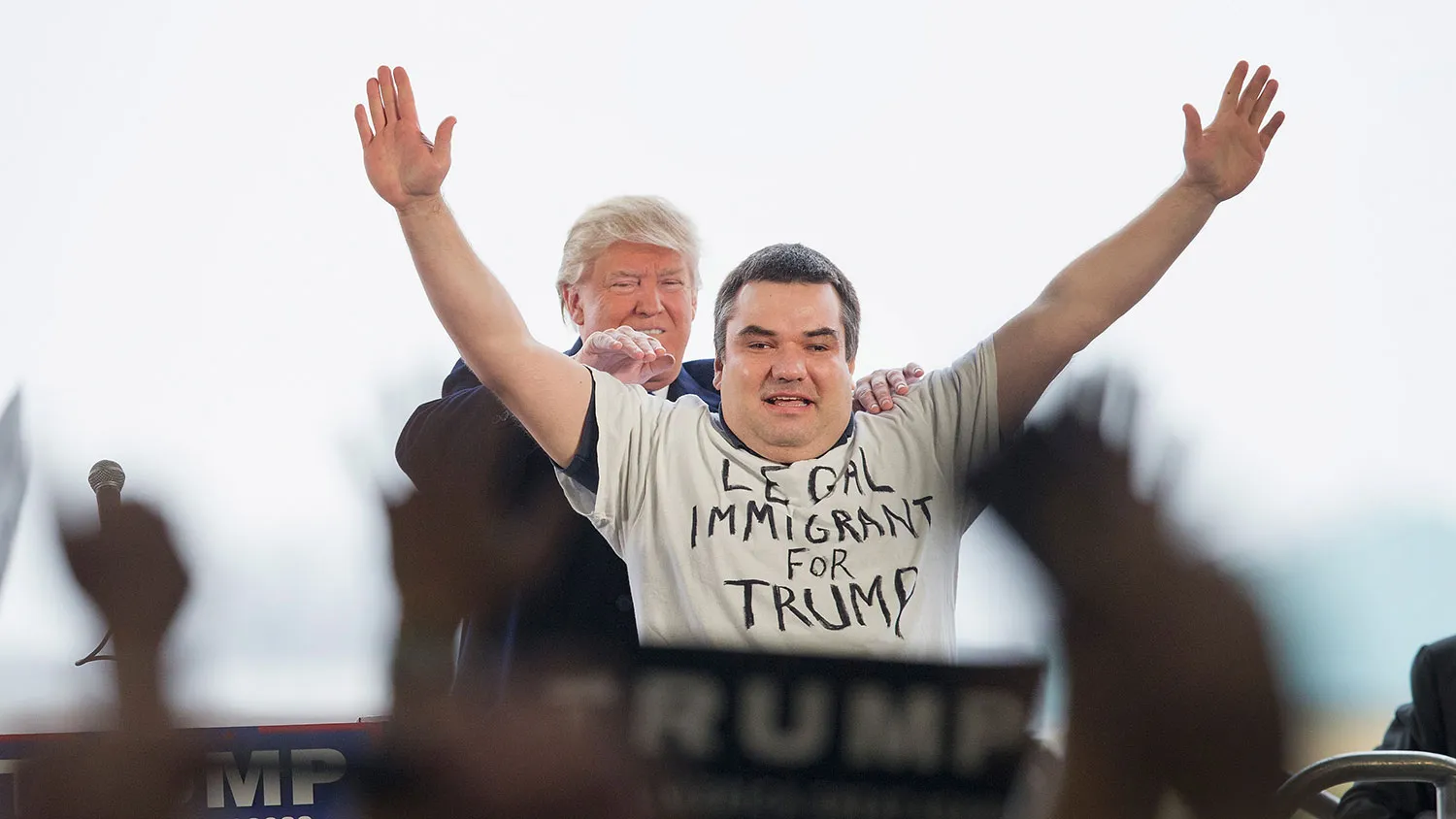 Republican presidential candidate Donald Trump pulls Alex Stypik from a crowd of supporters to show off his shirt during a rally at the Central Illinois Regional Airport on March 13, 2016, in Bloomington, Illinois.
